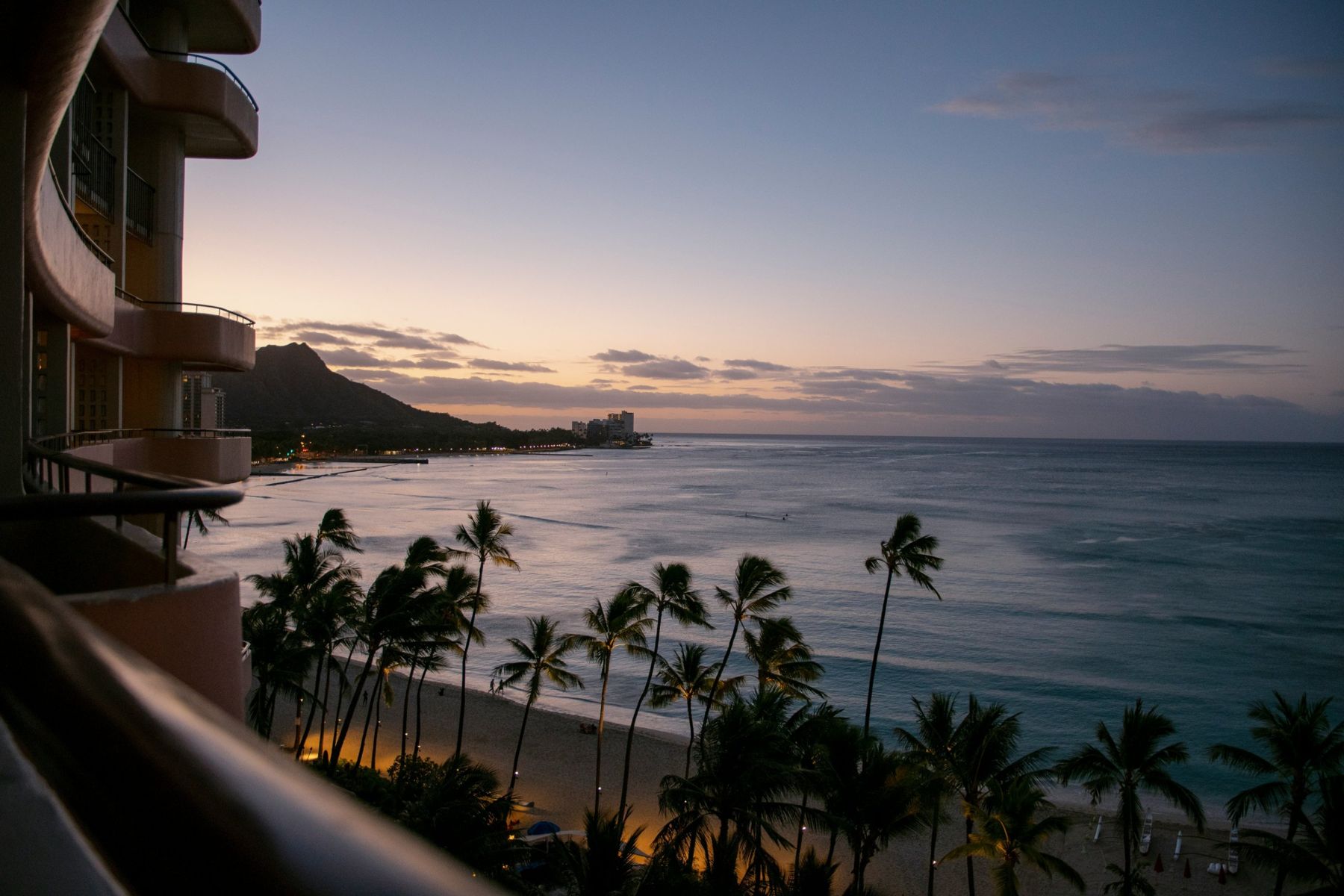 Dusk over Waikiki and Diamond Head from a high-rise balcony